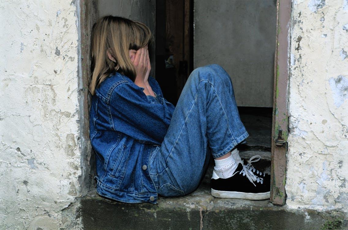 Free Lonely Girl sitting on a Doorway  Stock Photo